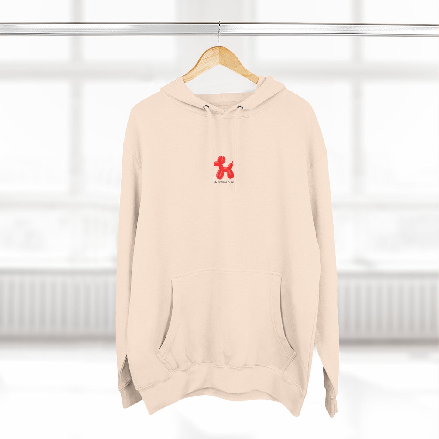 sandshell pullover hoodie with my dog thinks i'm cool text and red balloon dog graphic on hanger