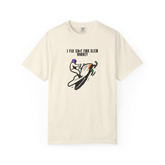 beige t-shirt with snowmobile graphic design and text on a white background
