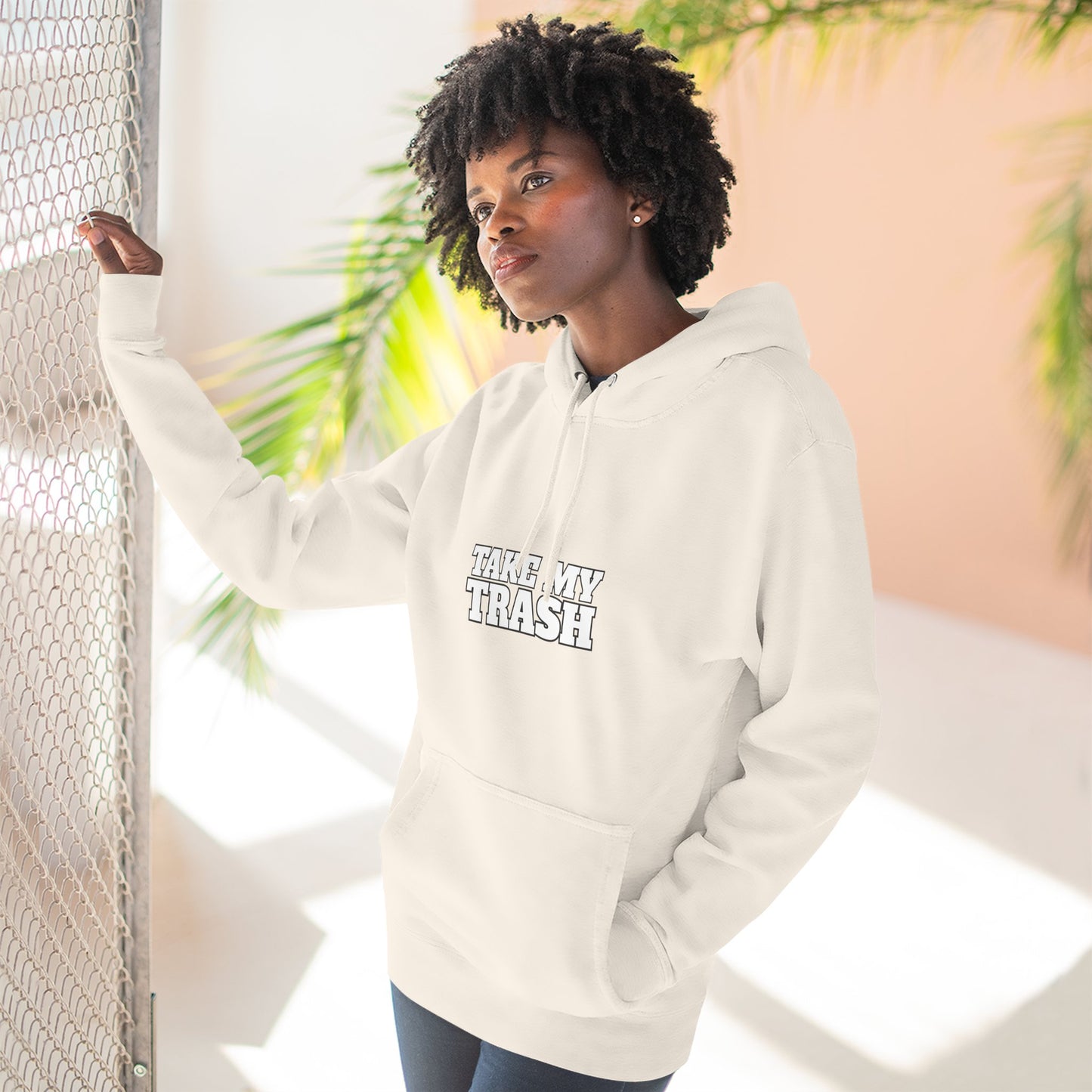 person wearing light color pullover hoodie with TAKE MY TRASH text - funny breakup hoodie anti-Valentine's