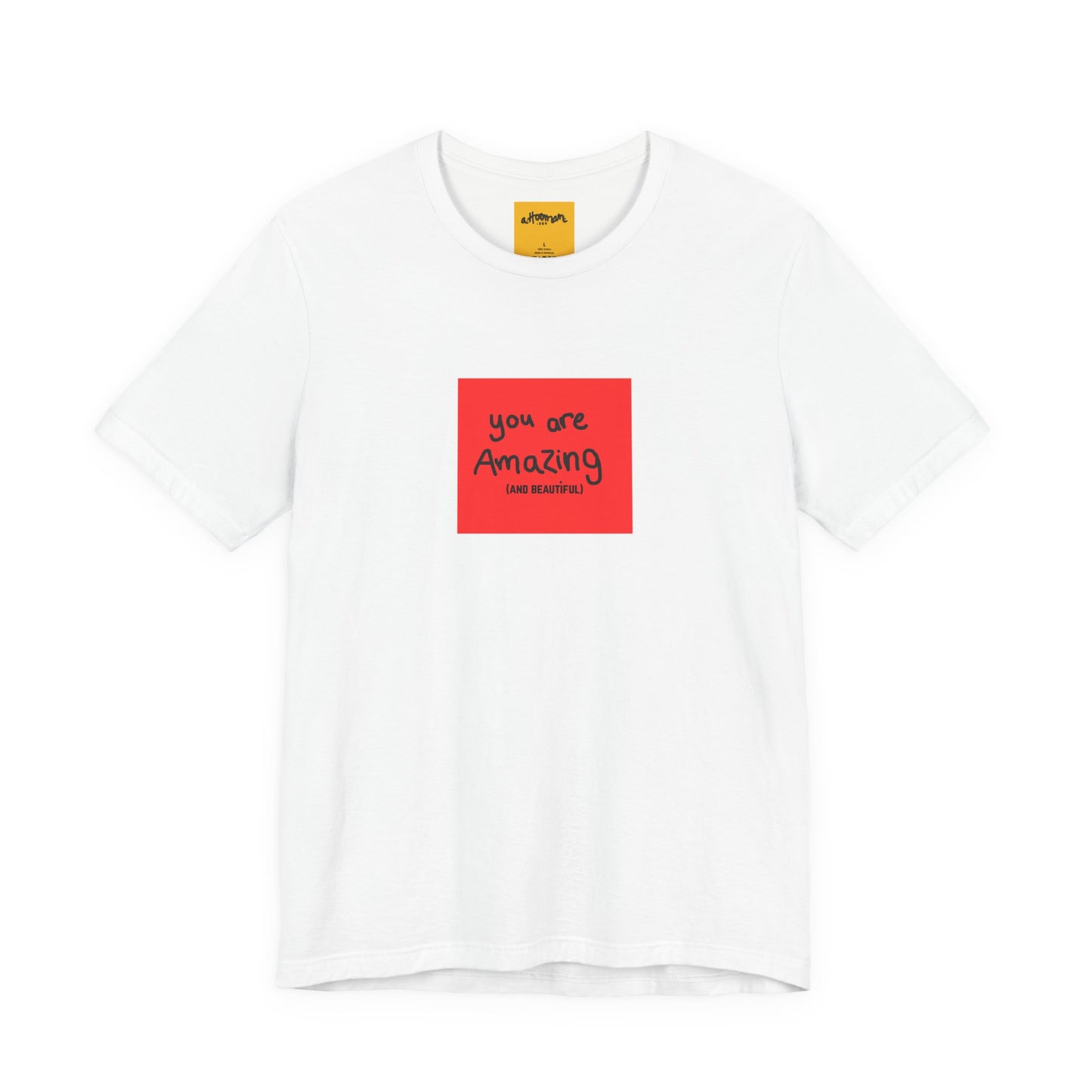 white t-shirt with a red square and text  reads you are amazing and beautiful on a white background