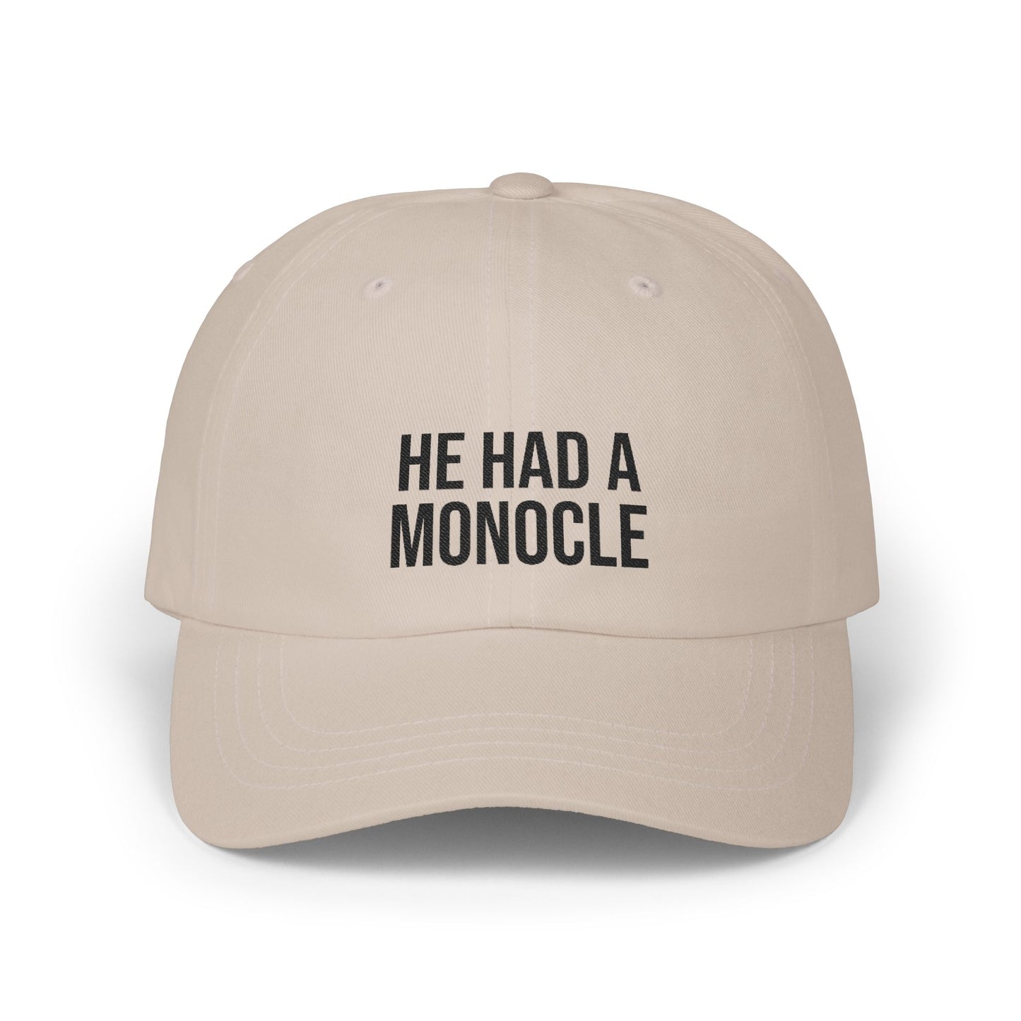 Beige cap with 'HE HAD A MONOCLE' text on a white background